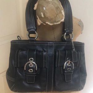 Coach black leather medium size handbag with silver hardware. Expandable .
